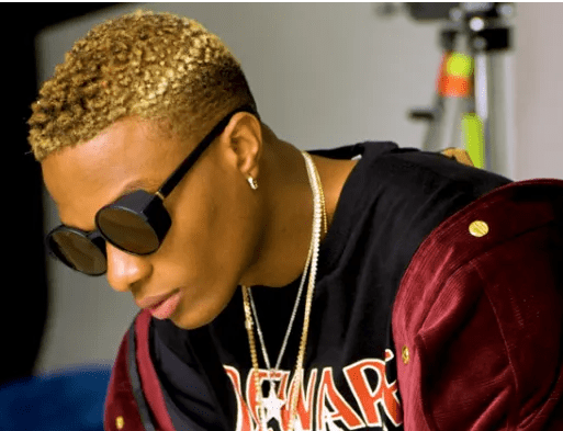 Wizkid shares new photo as he rocks a 'million dollar' holster in his Ferrari